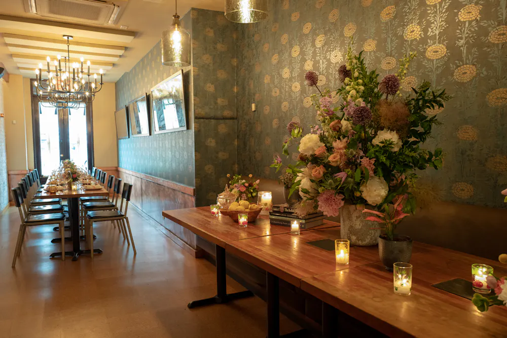 a living room filled with furniture and vase of flowers on a table