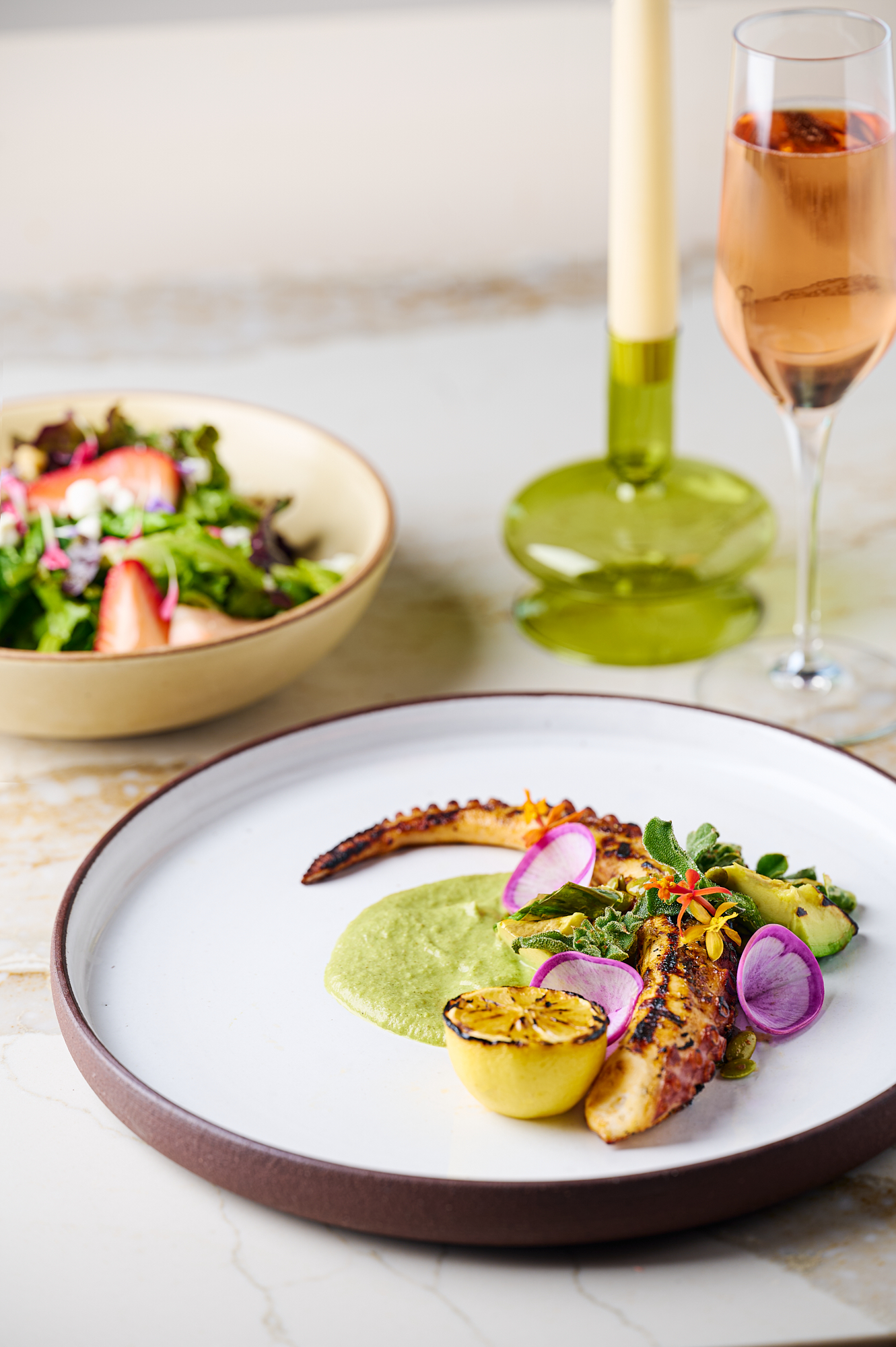 a plate of food and a glass of wine