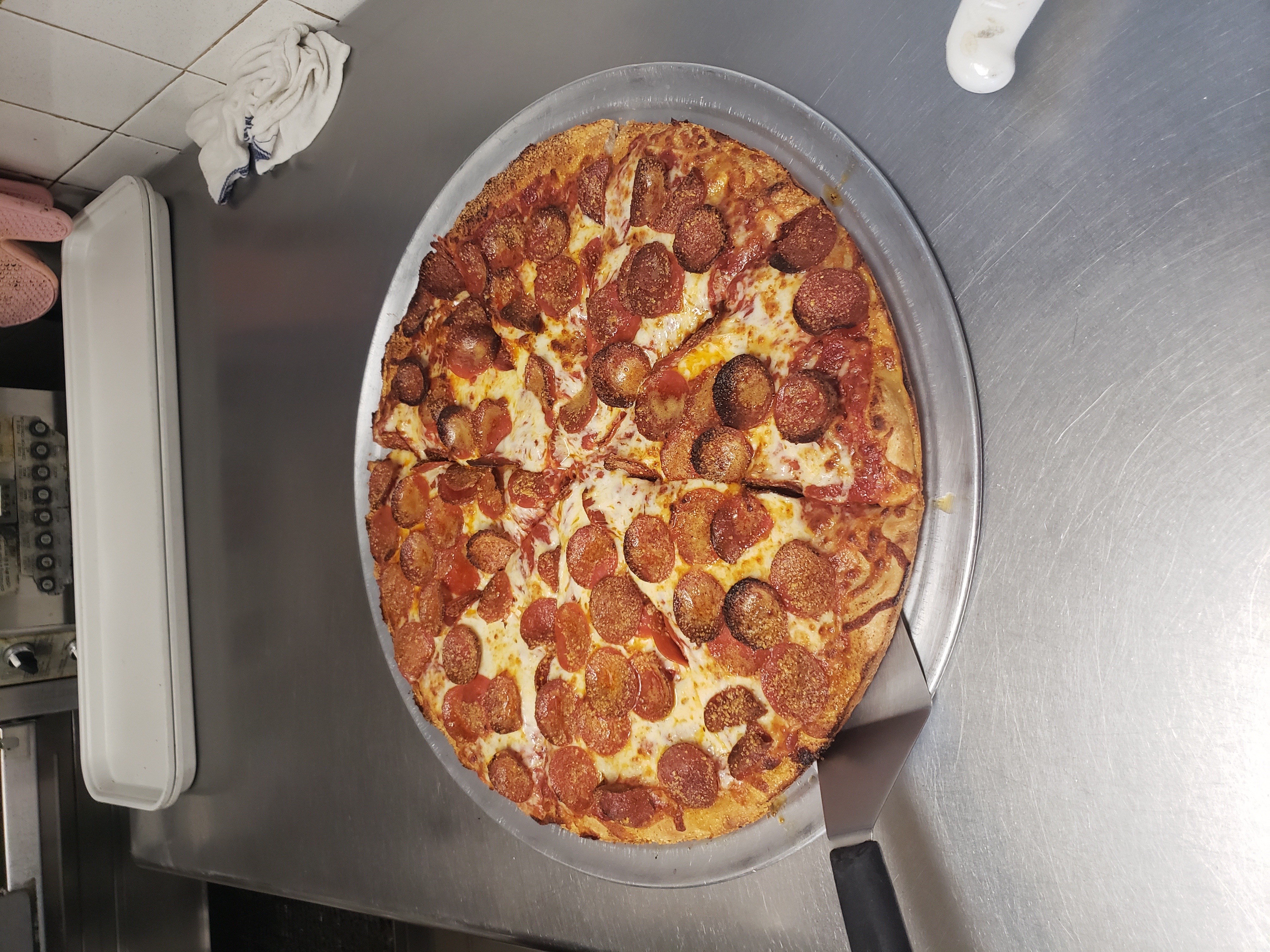 a pizza sitting on top of a pan on a table