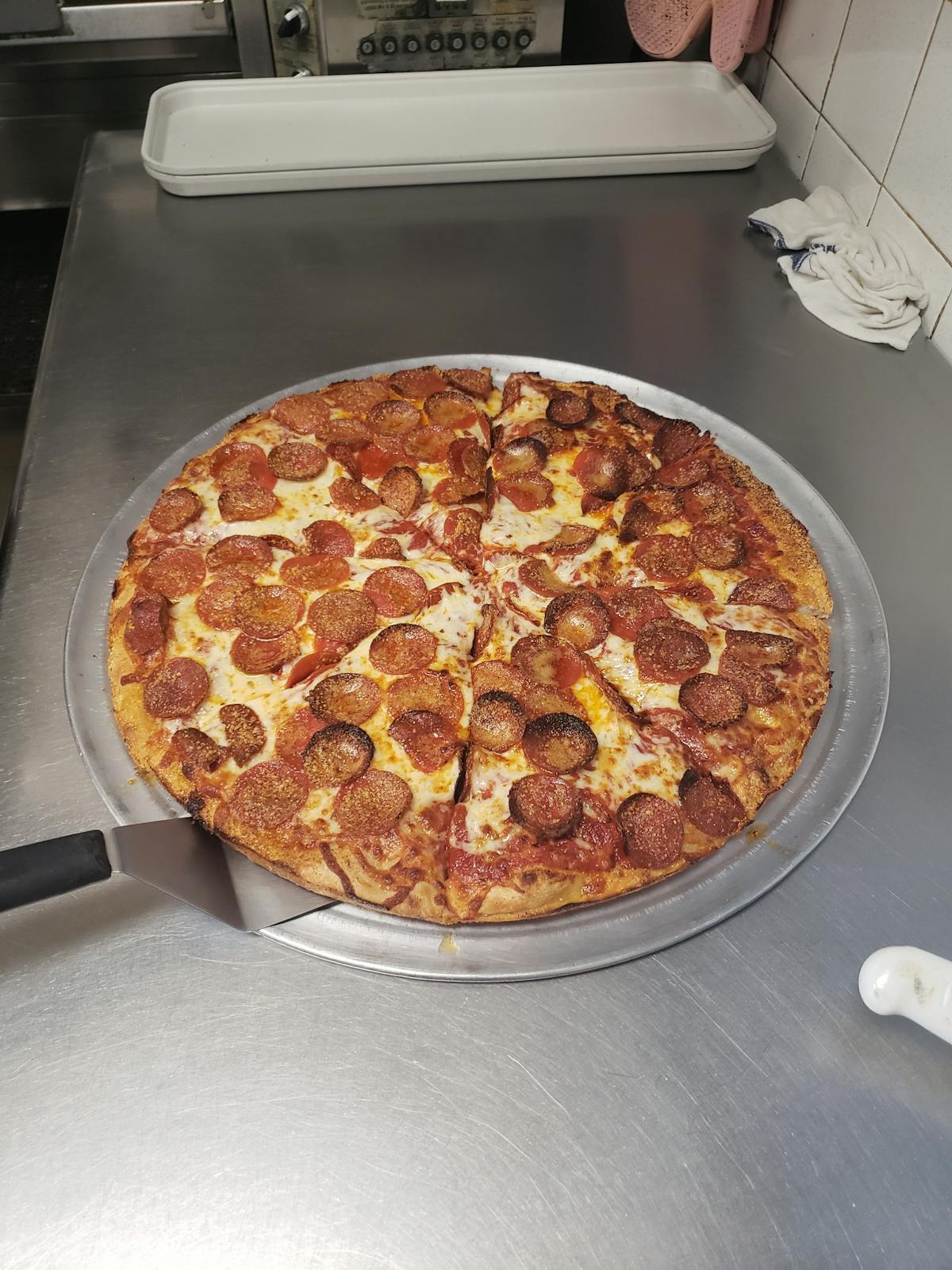a pizza sitting on top of a pan on a table