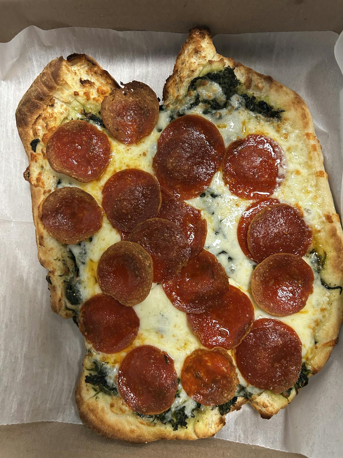 a close up of a pepperoni pizza in a box