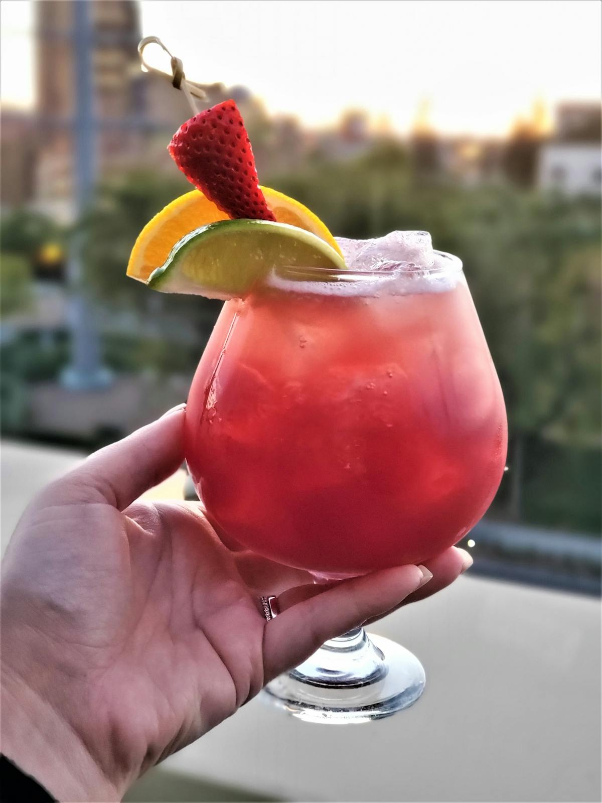 a hand holding a cocktail