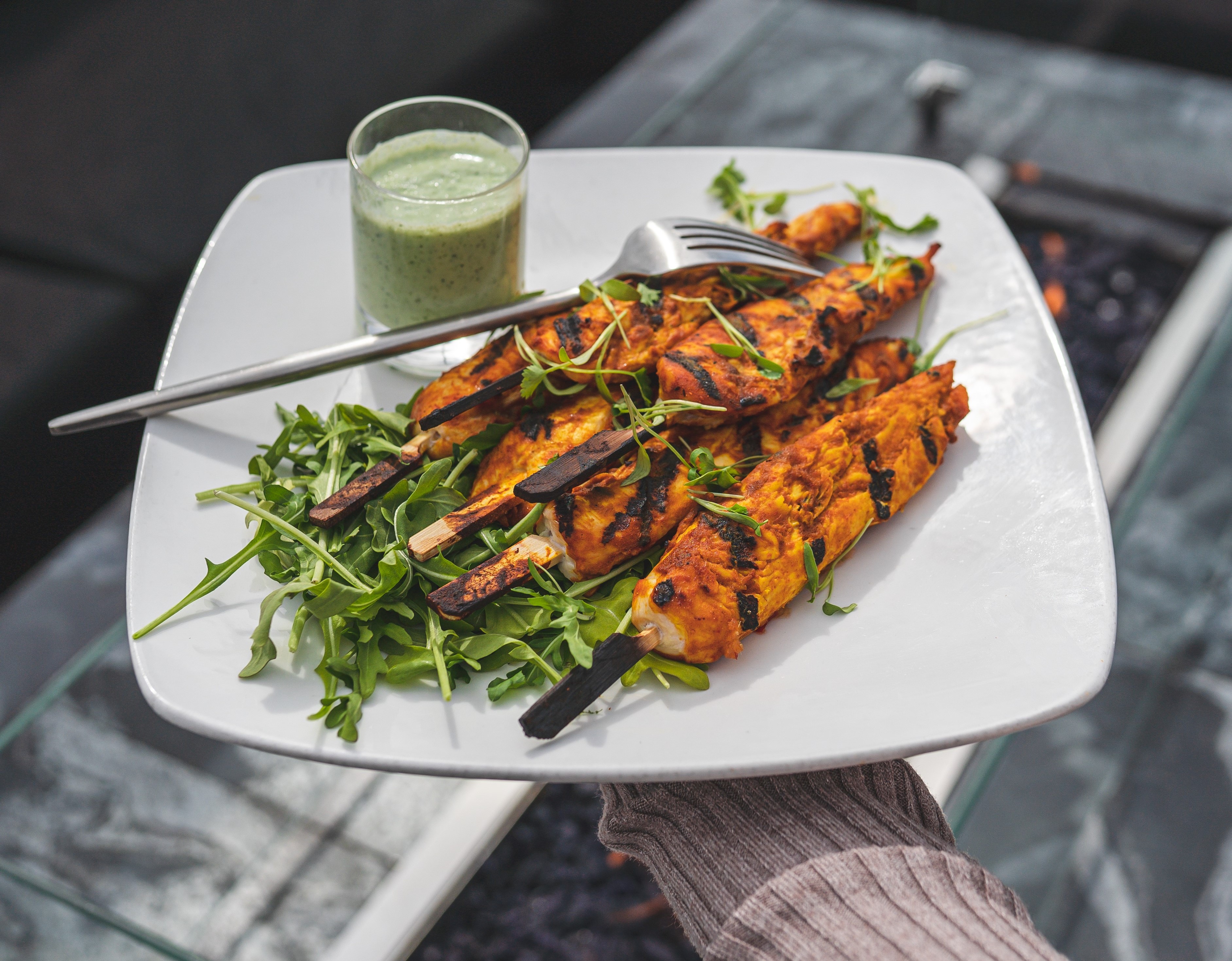 holding chicken tikka skewers