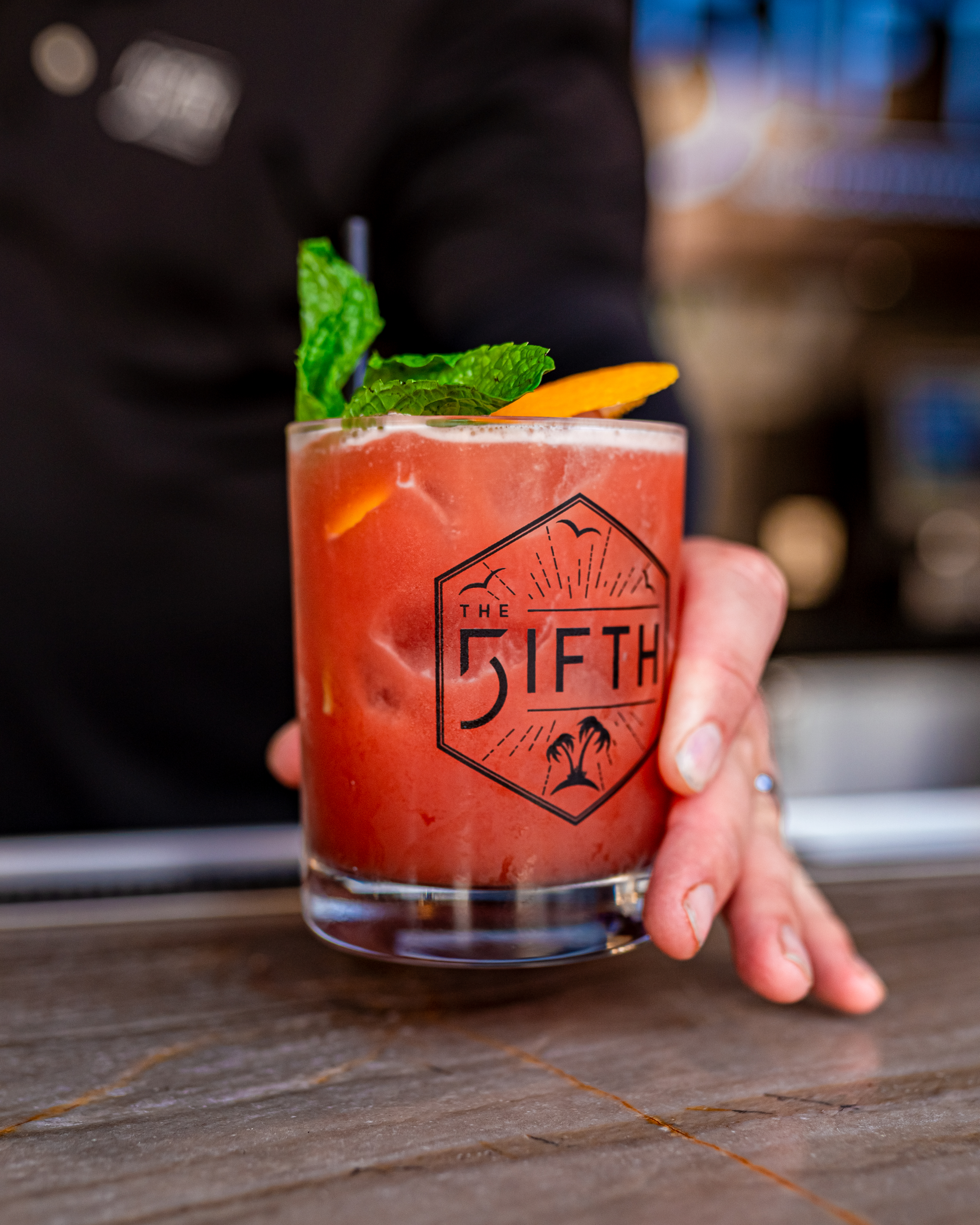 a hand holding a drink