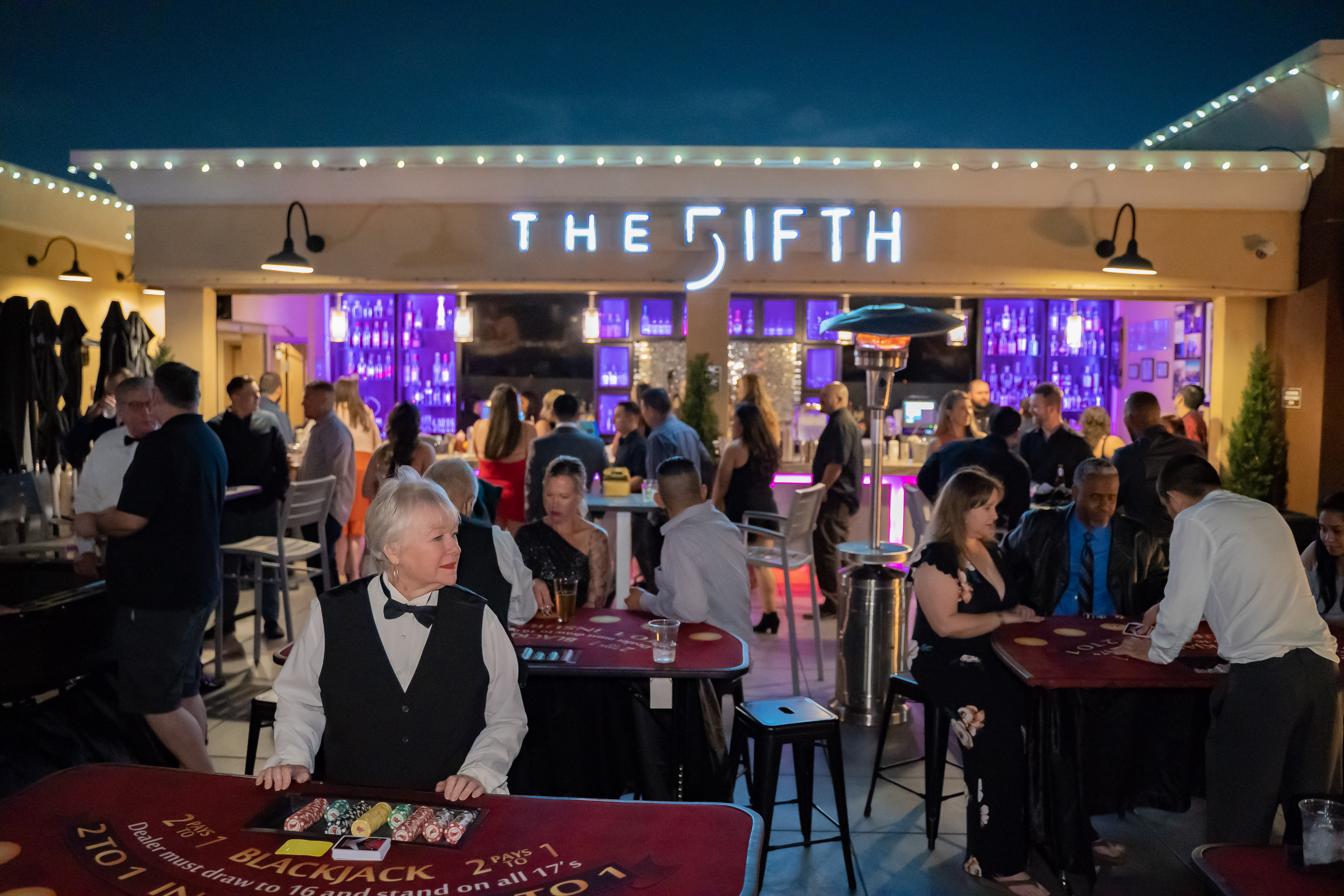 a group of people sitting at a table in front of a crowd