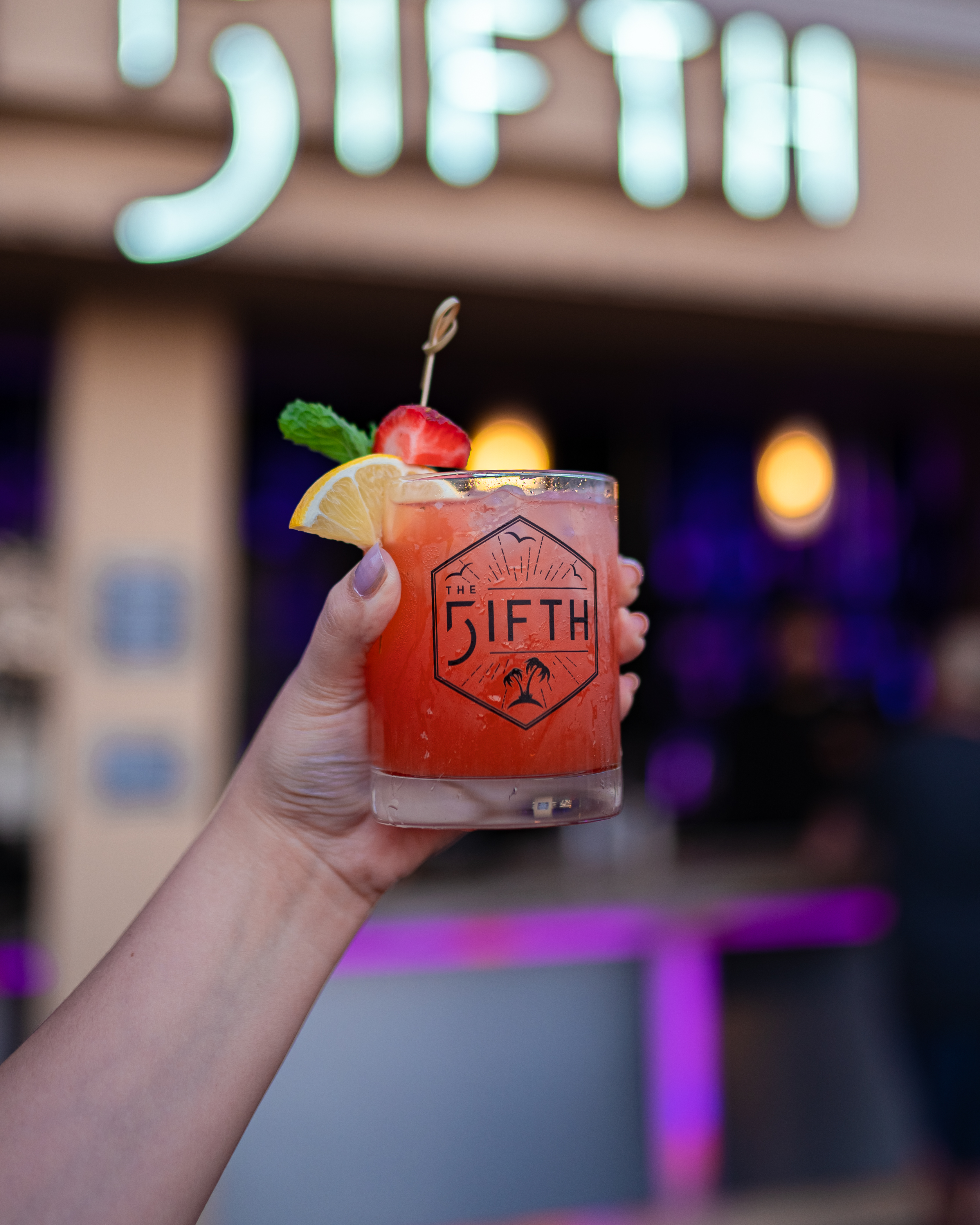 a hand holding a drink