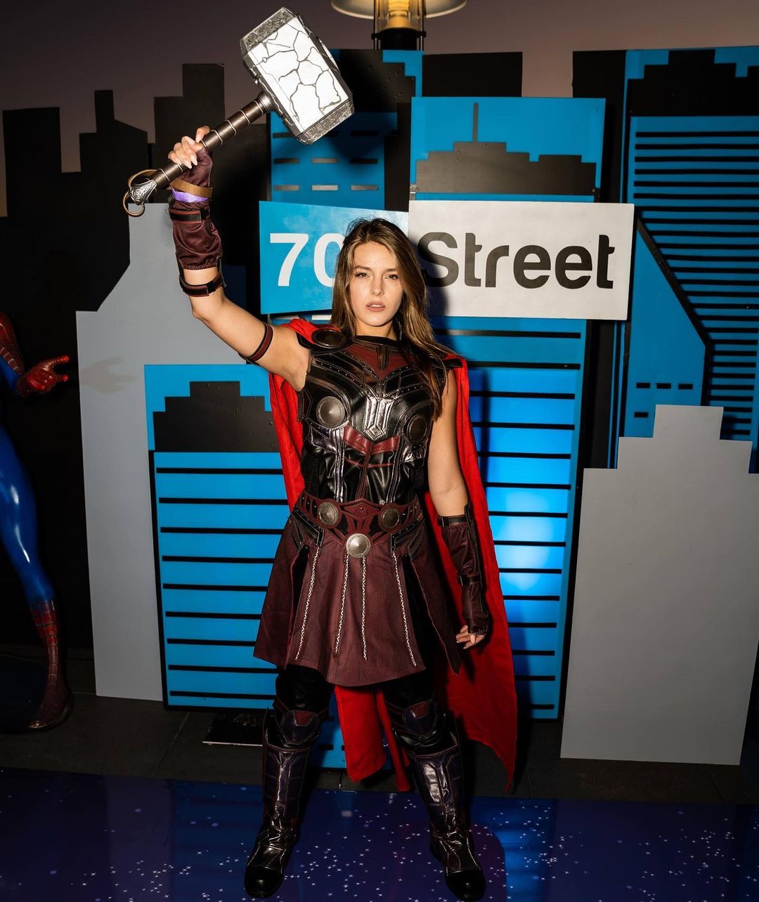 a woman holding a sign posing for the camera