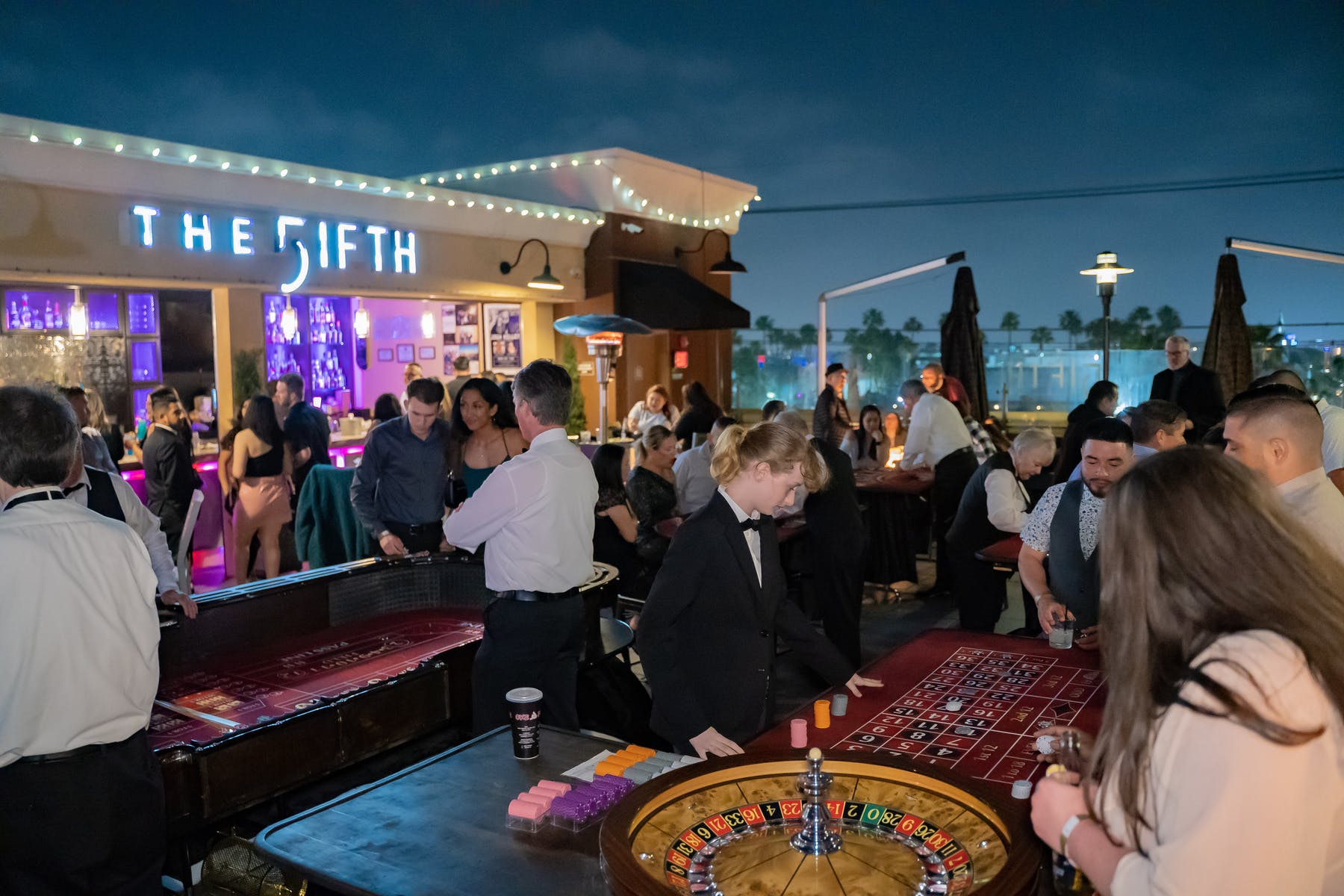 a group of people standing around a table