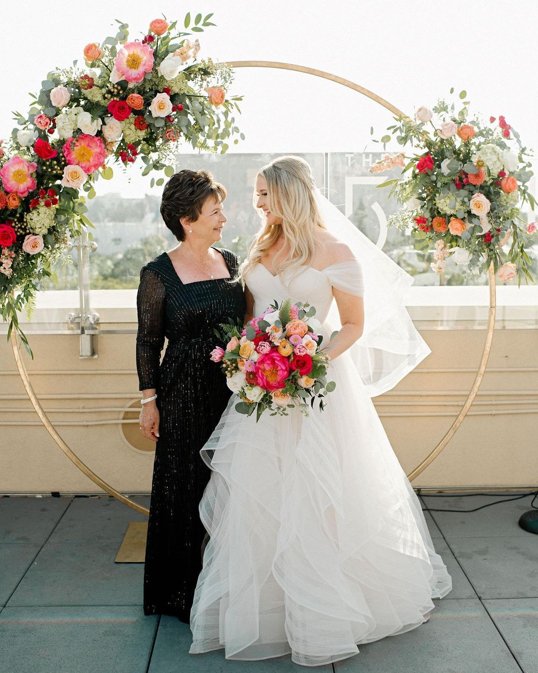 a woman standing in front of a flower