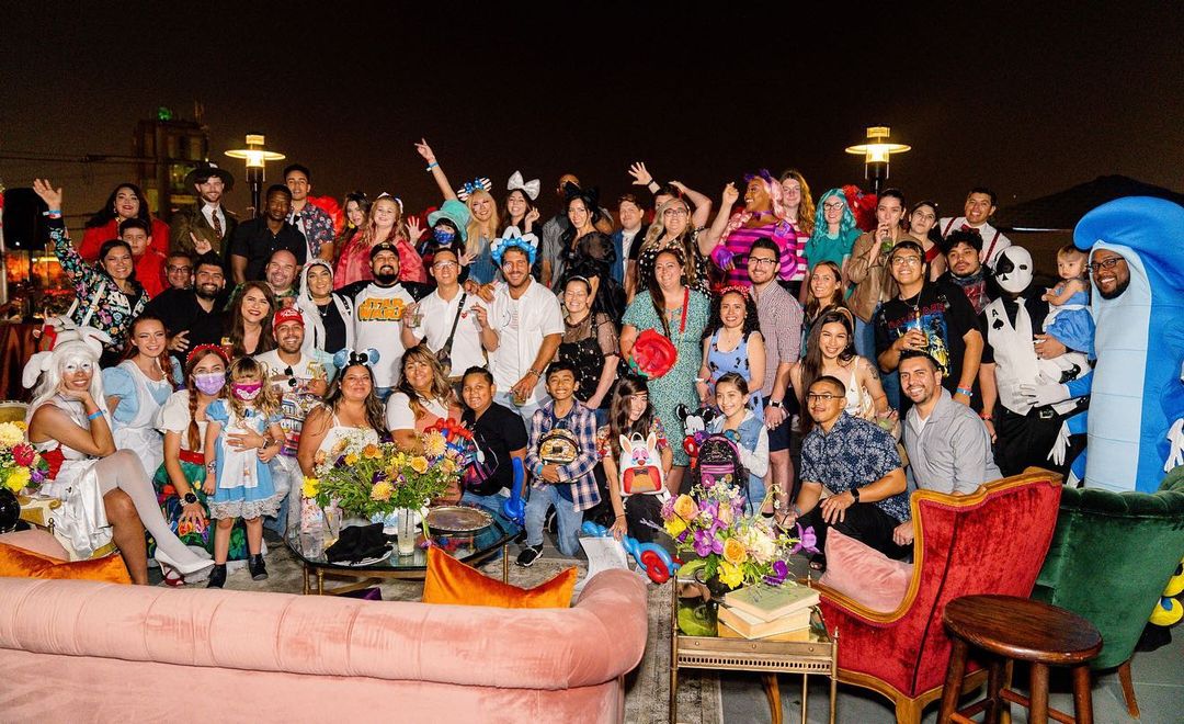 a group of people sitting in front of a crowd posing for the camera