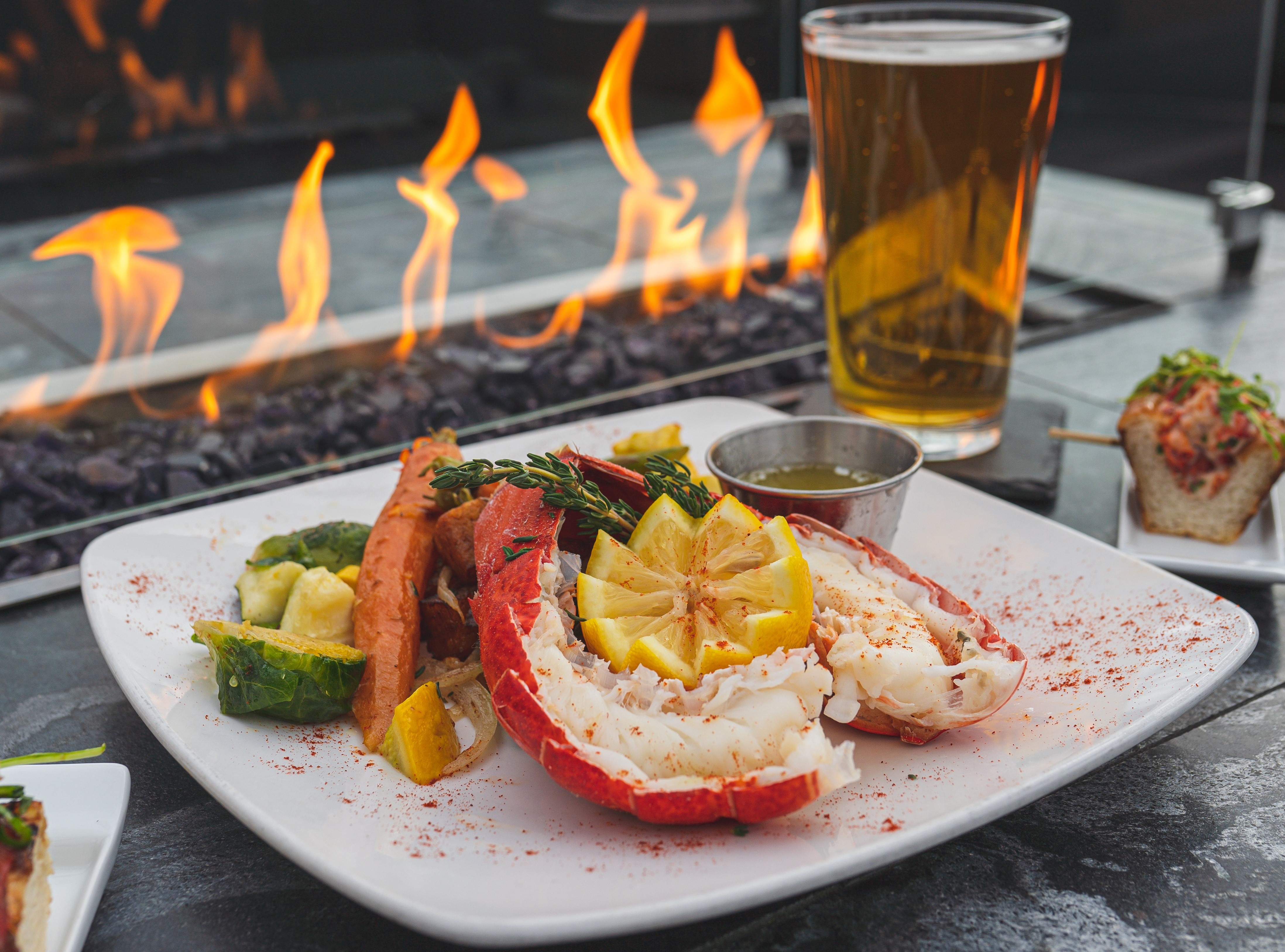lobster tails entrée in front of fire