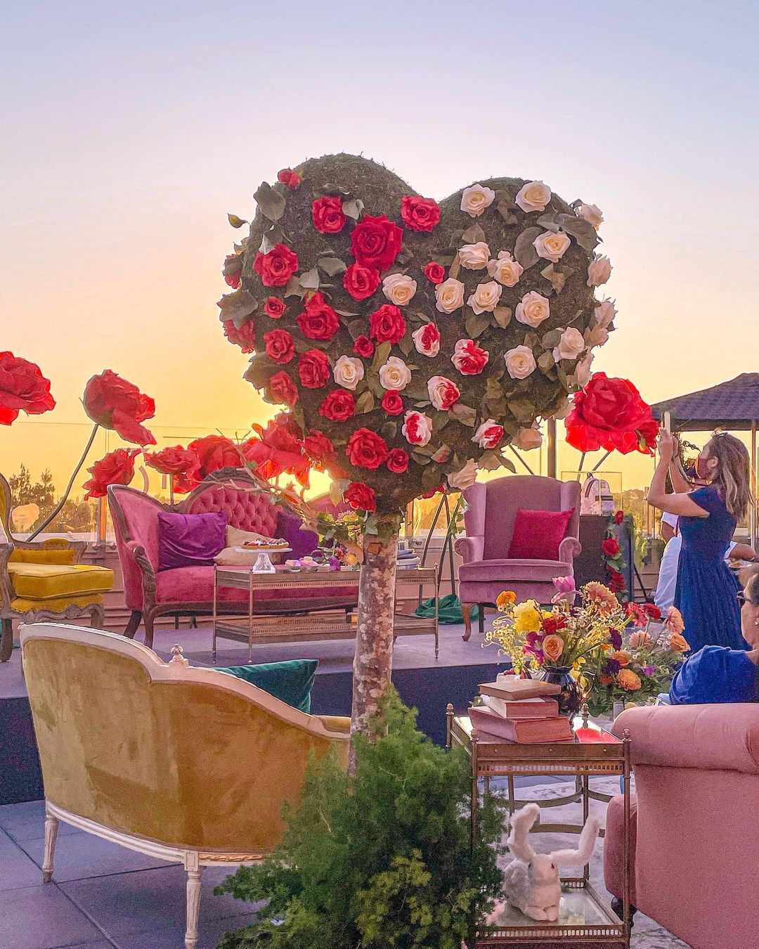 a room filled with furniture and vase of flowers on a table