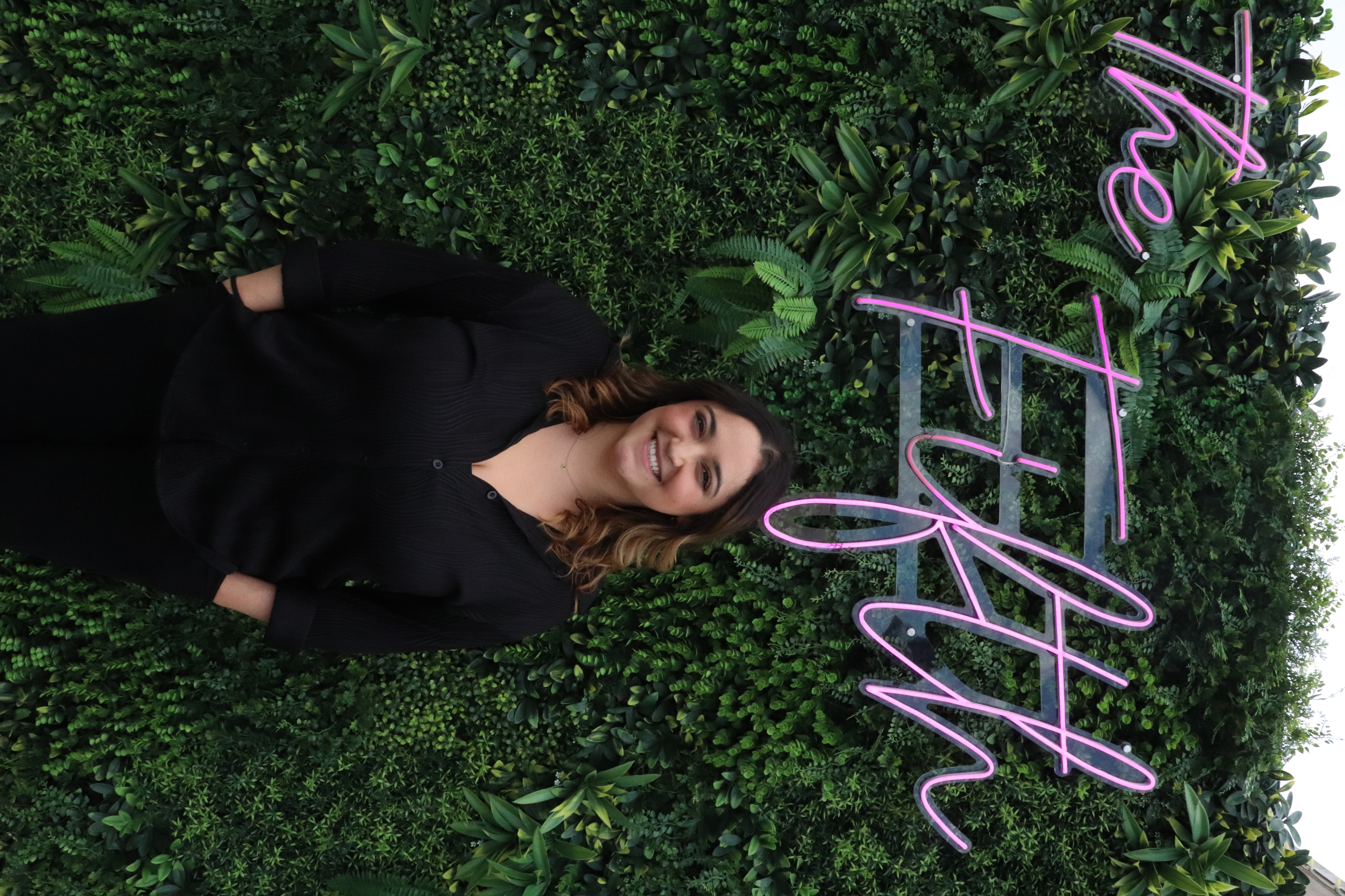 a woman standing in front of a sign