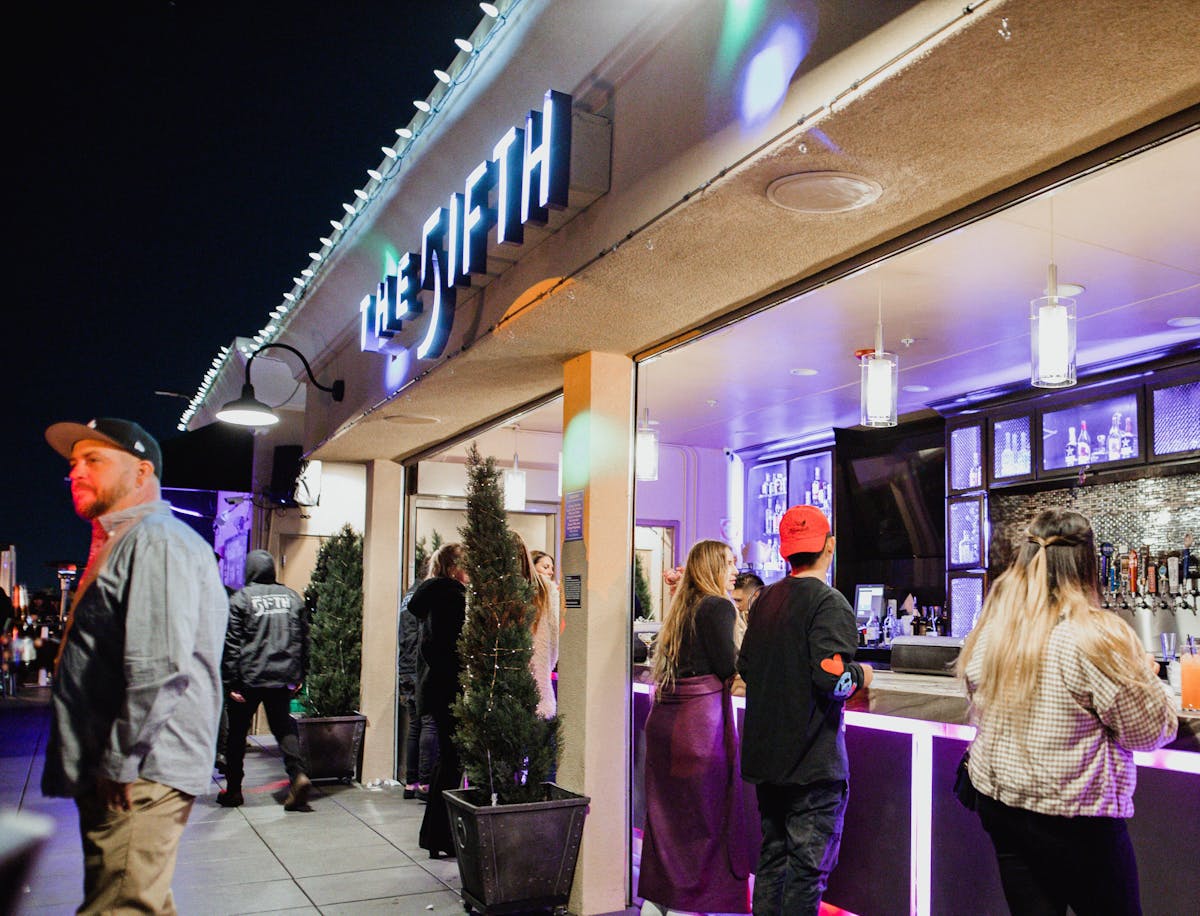 a group of people standing by the bar