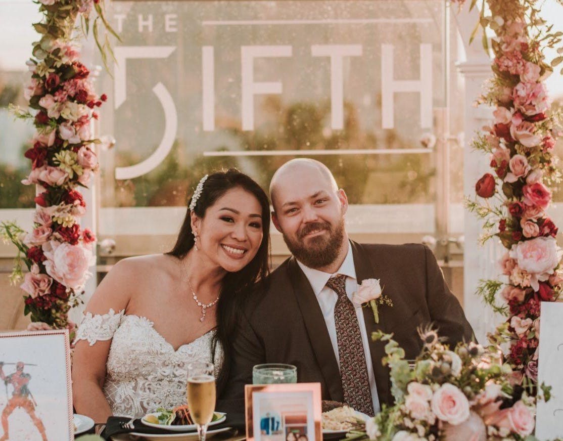 a woman standing in front of a flower