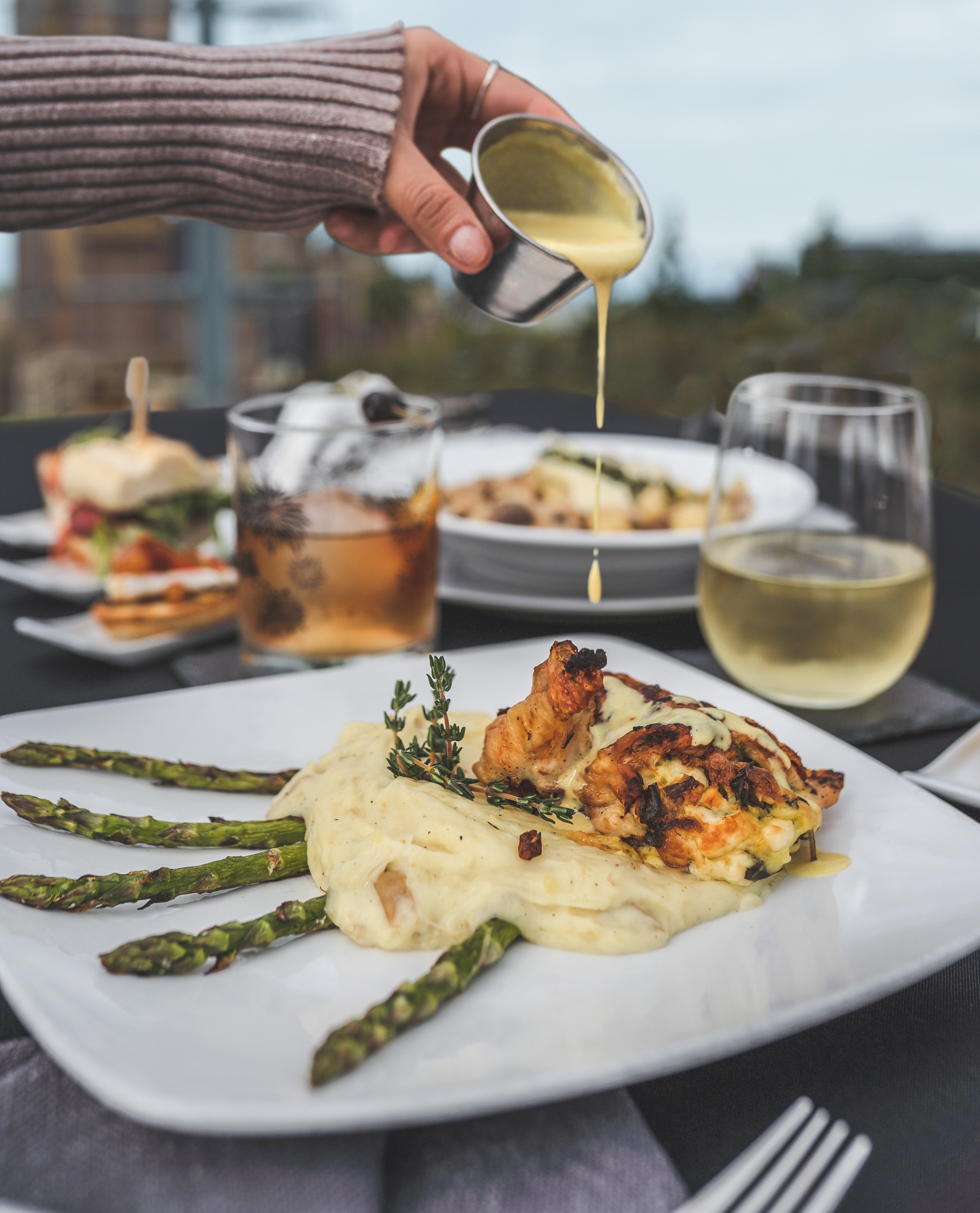 sauce being poured over chicken