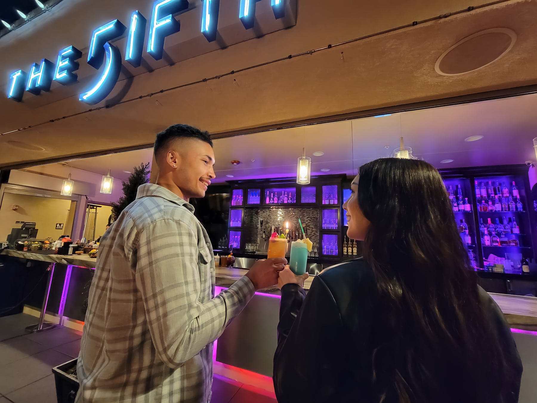 a couple cheering drinks