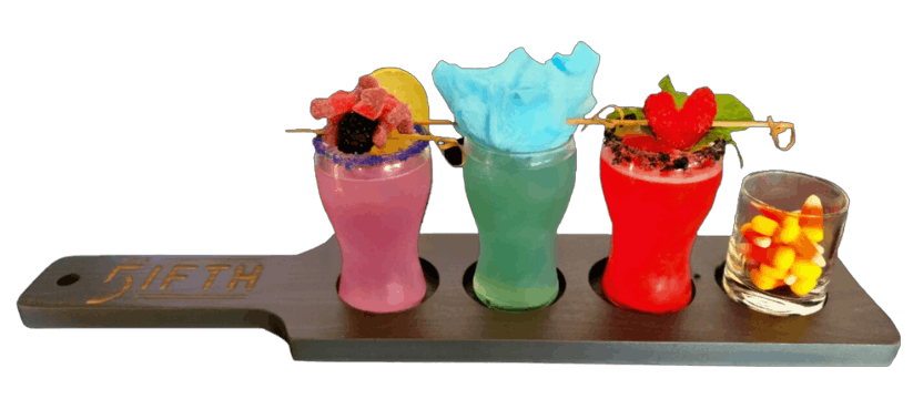 cocktail served in seashell with boba and garnishes on top