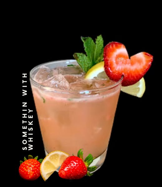 Somethin with whiskey. Image: pink cocktail and lemon and strawberry garnishes