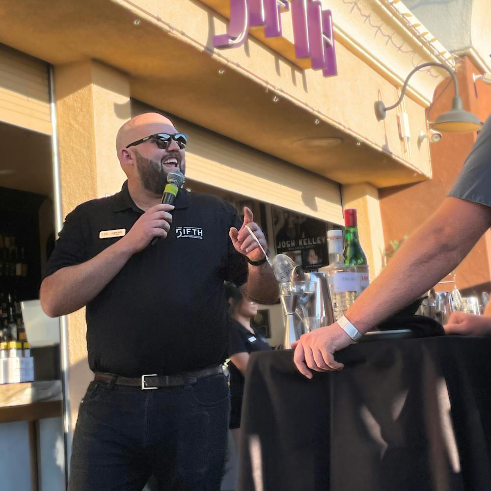 Jason from The FIFTH teaching a mixology class in front of the FIFTH bar.