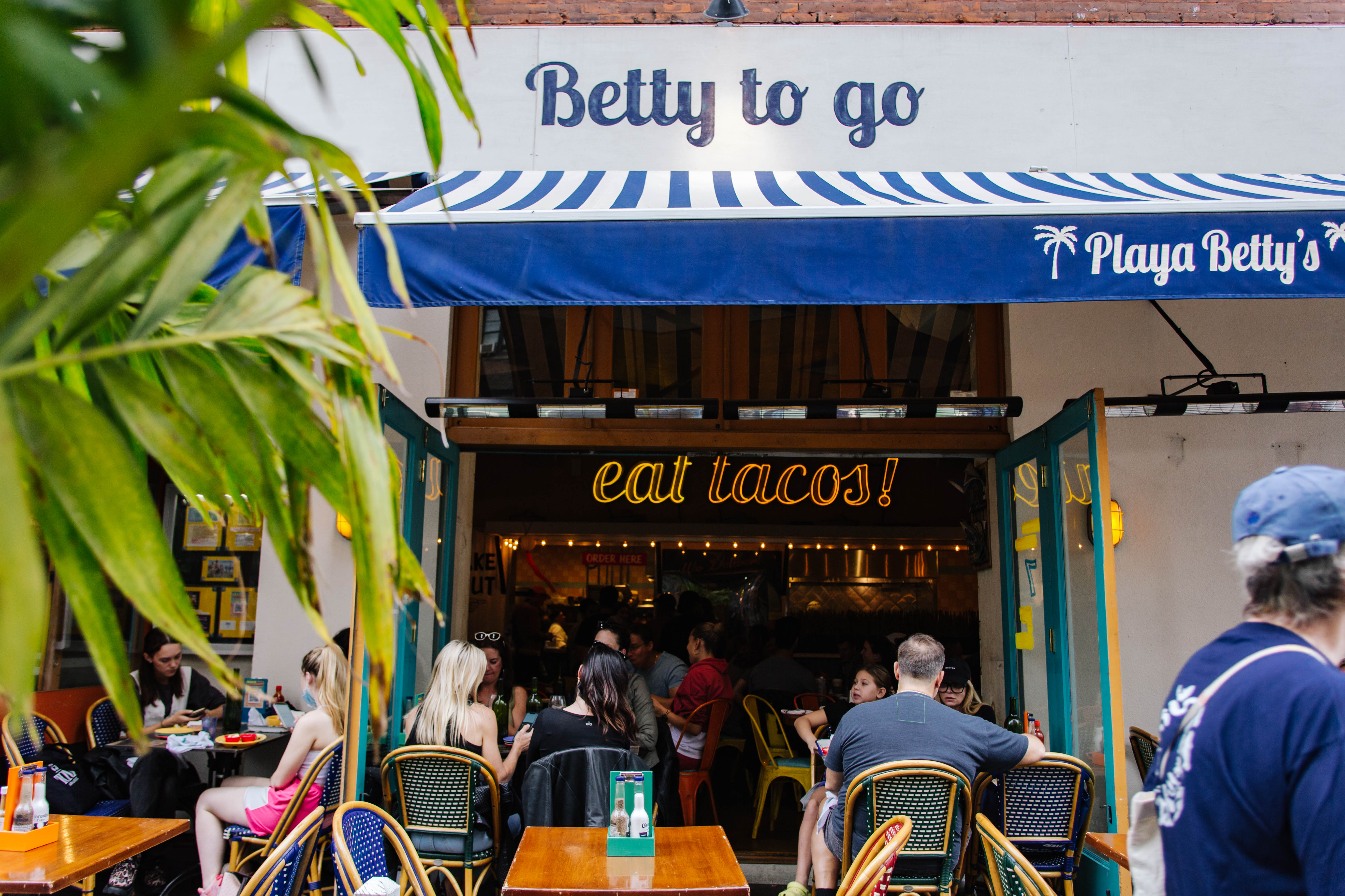 a group of people standing in front of a store