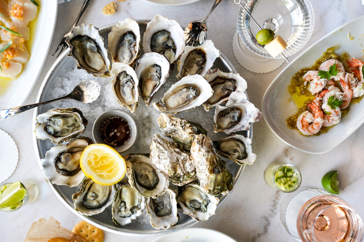 $2 Oysters with martinis on a table.