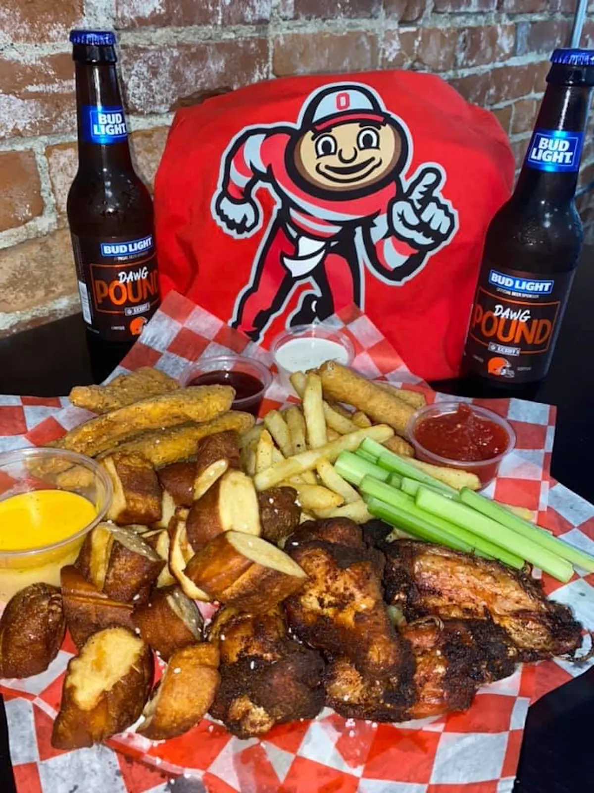a bottle of beer next to a pile of fries