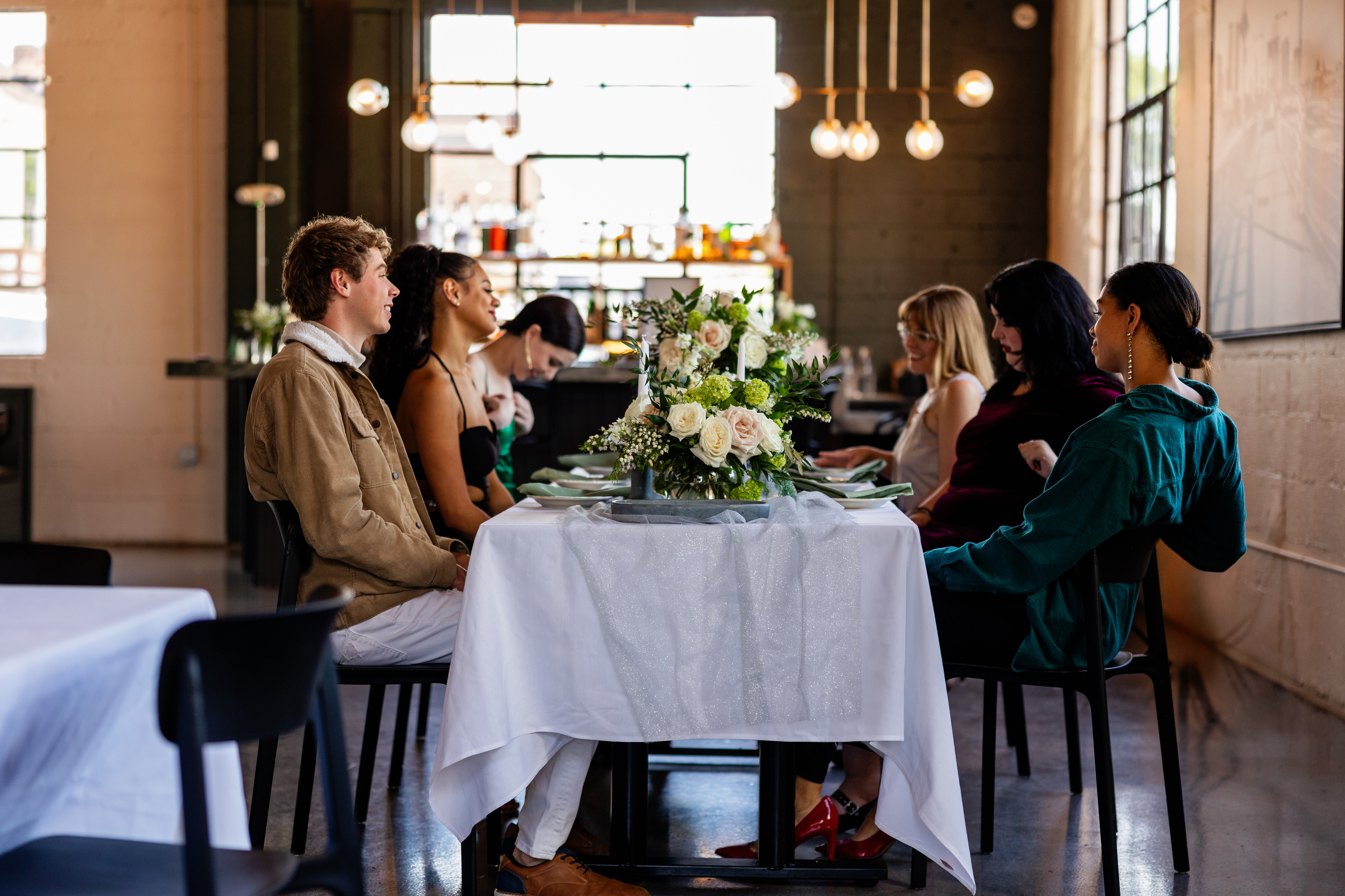 a woman sitting at a table in a restaurant