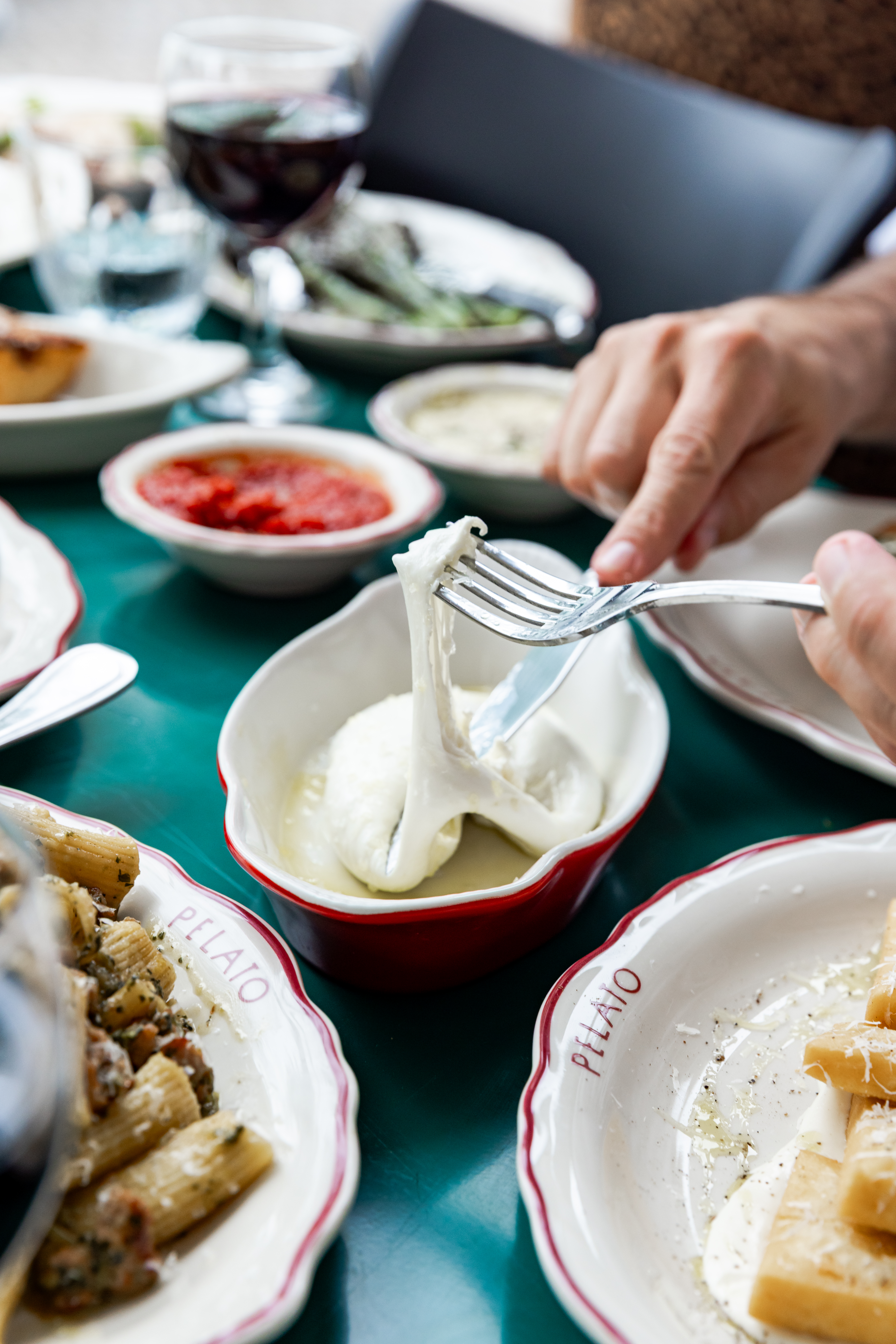 a person sitting at a table with a plate of food