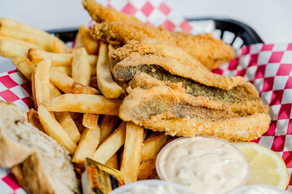 a close up of a sandwich and fries on a plate