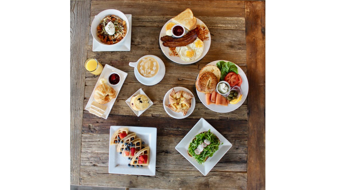 an overview of a table filled with multiple plates of food