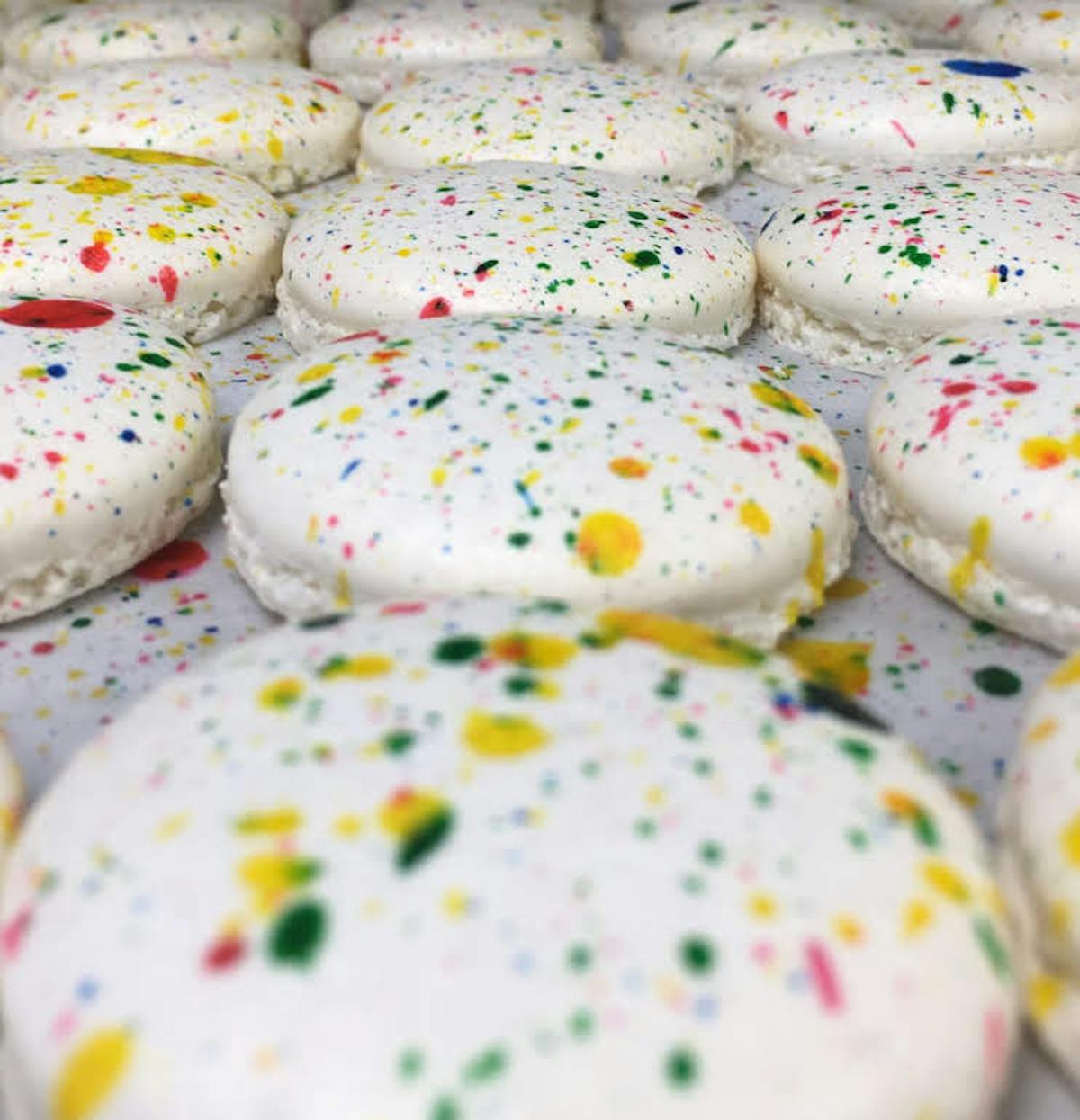 multiple decorated cookies sitting on a table