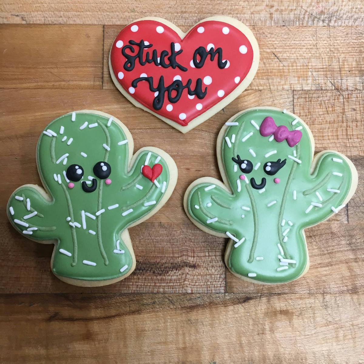 multiple decorated cookies sitting on a table