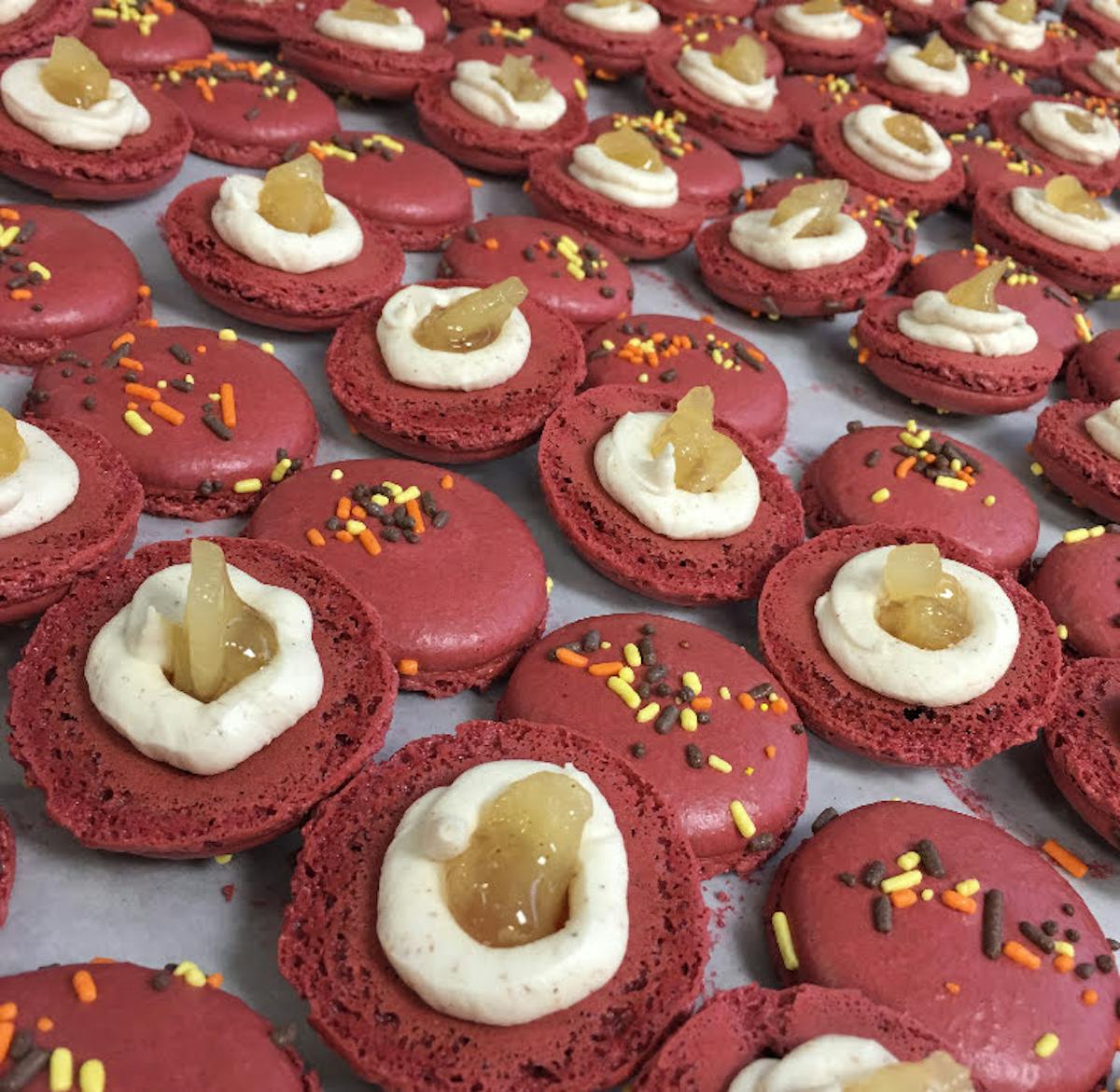 multiple decorated cookies sitting on a table