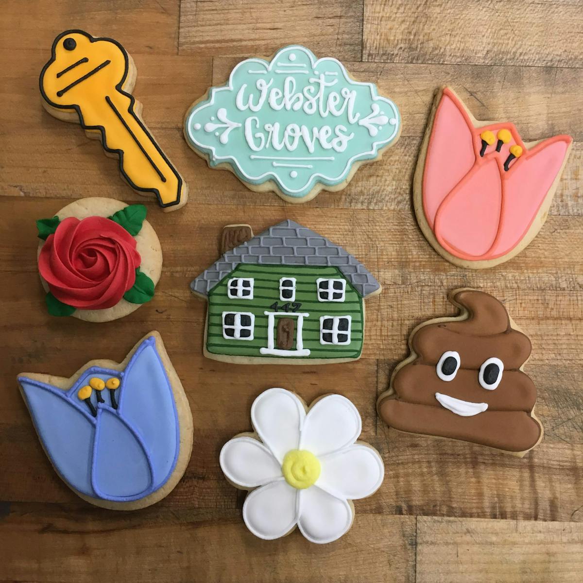 multiple decorated cookies sitting on a table