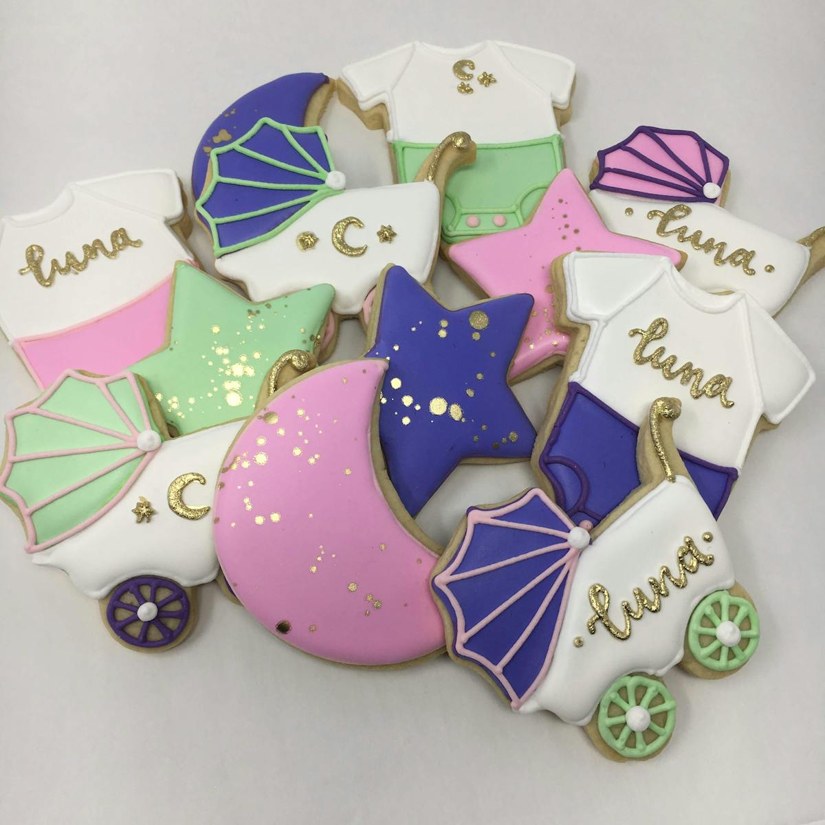 pram, moon, onesies, and star cookies for a lunar themed baby shower