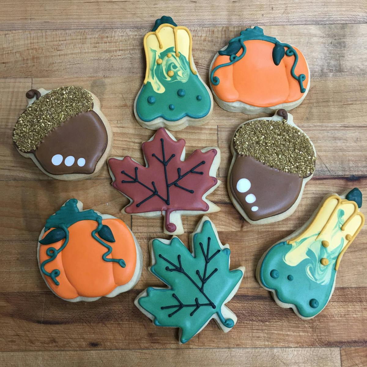 gourds, pumpkin, acorns, and leaves decorated cookies