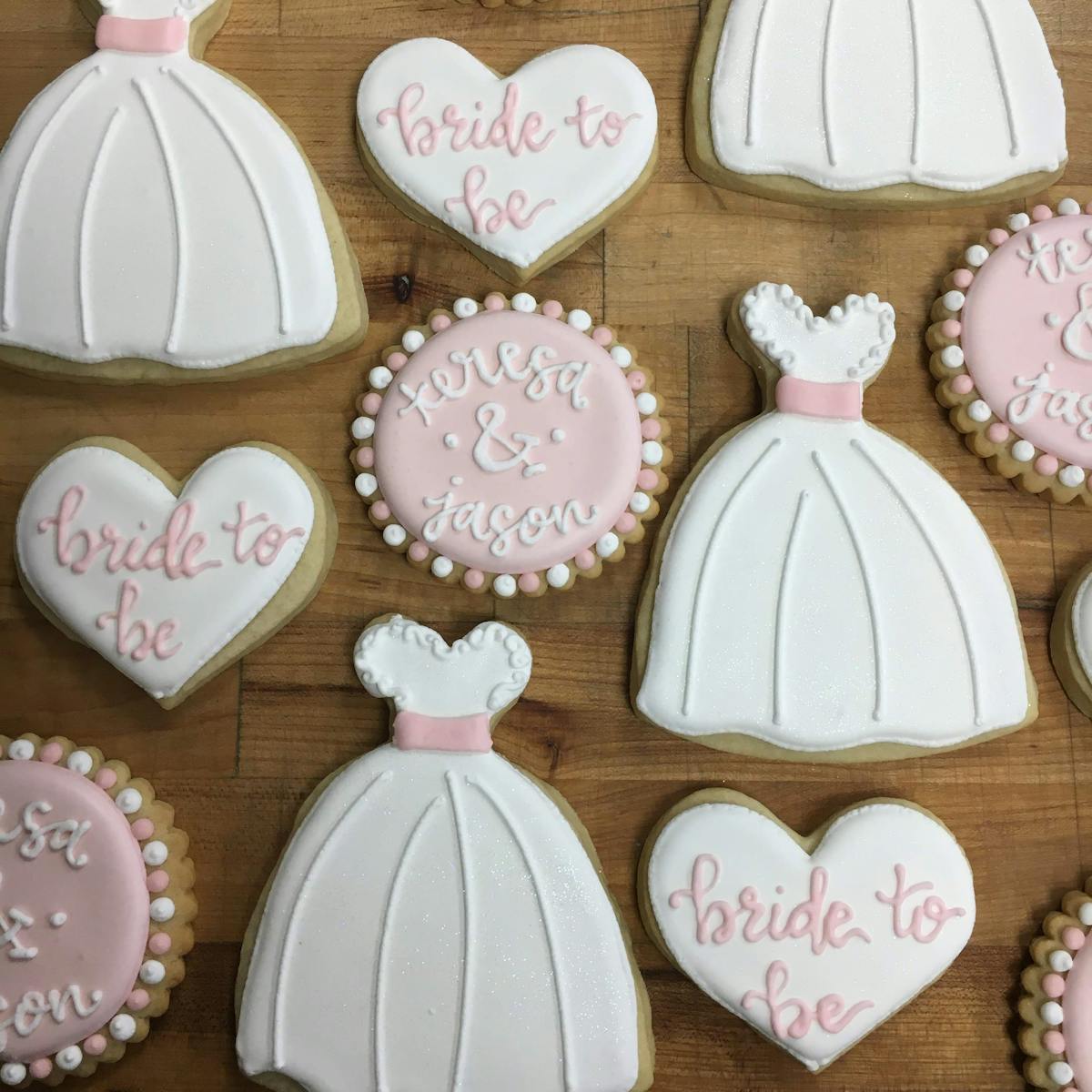 a group decorated cookies bridal/wedding items on a table