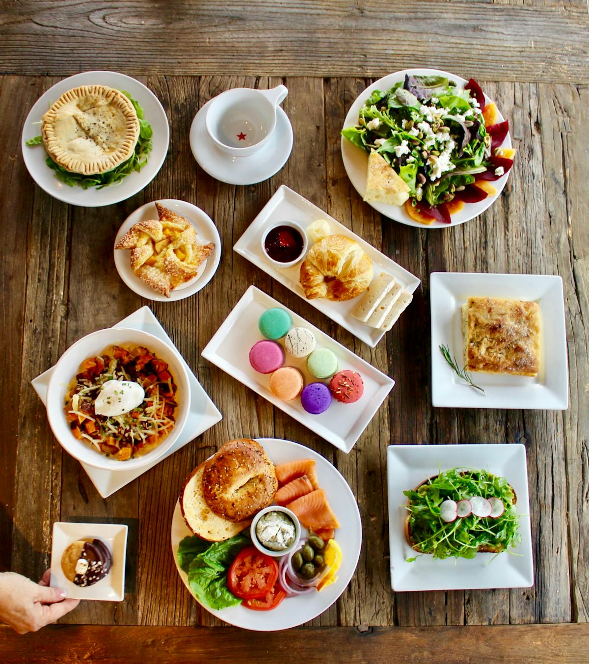 an overview of a table filled with multiple plates of food