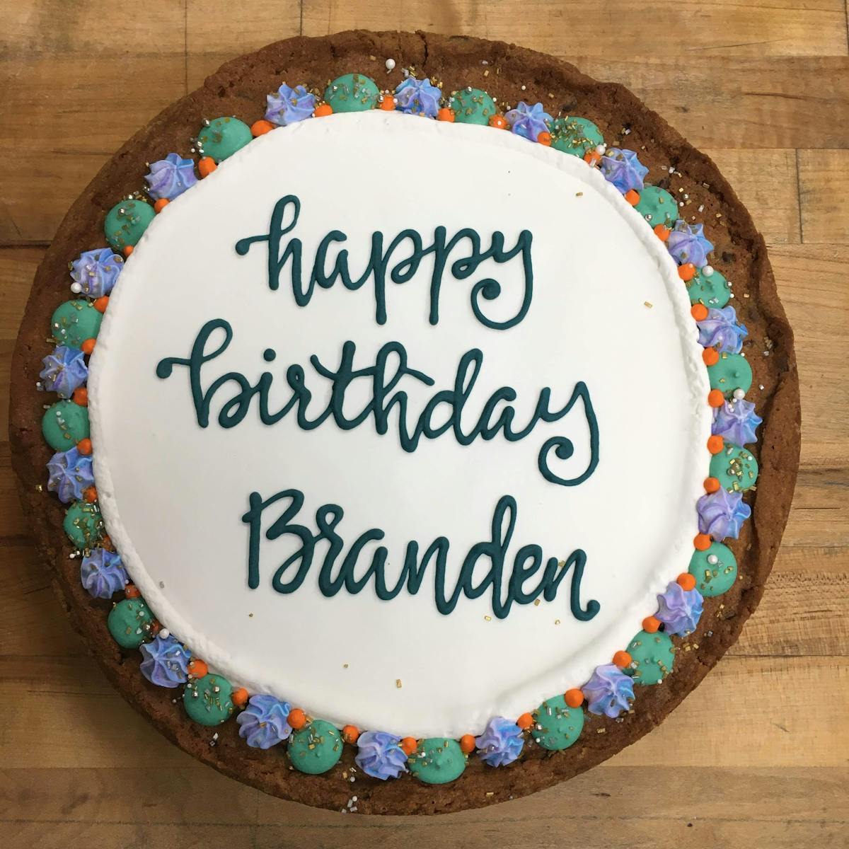 a sign on the side of a birthday cake