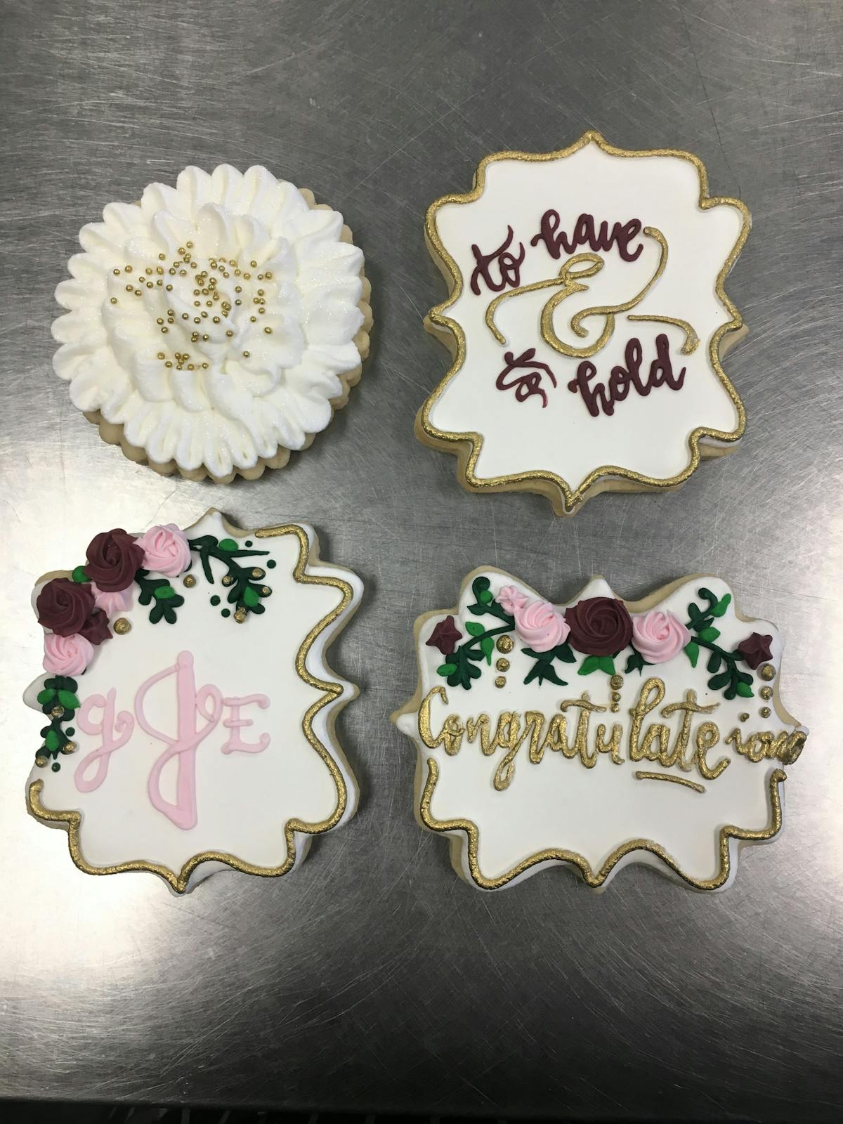 multiple decorated cookies sitting on a table