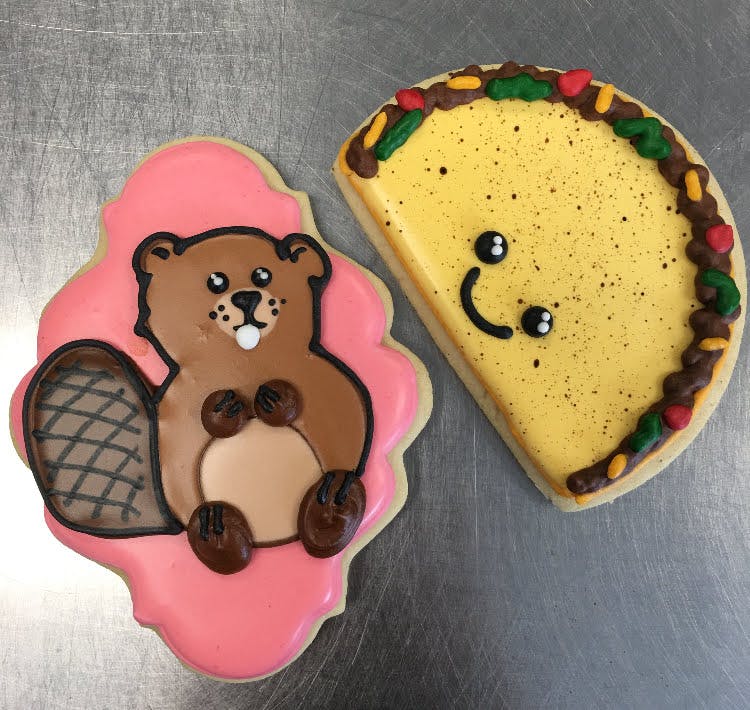 beaver shaped cookies next to a taco shaped cookie