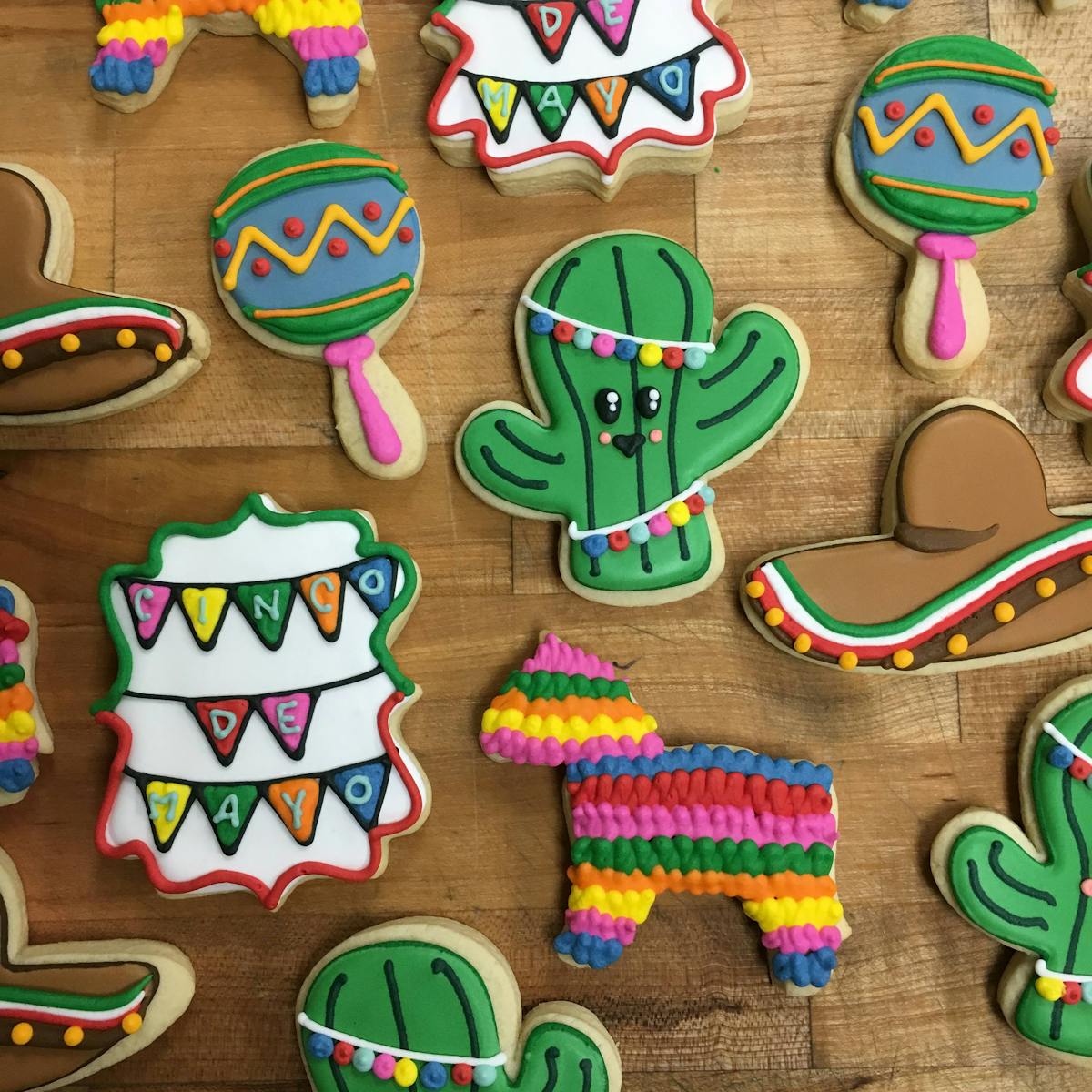 multiple decorated cookies sitting on a table