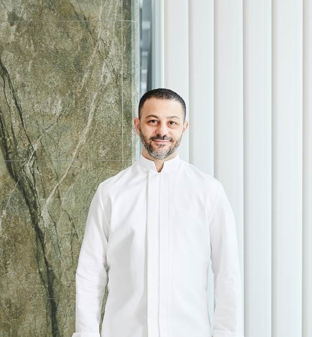 Salvatore Martone standing in front of a mirror posing for the camera