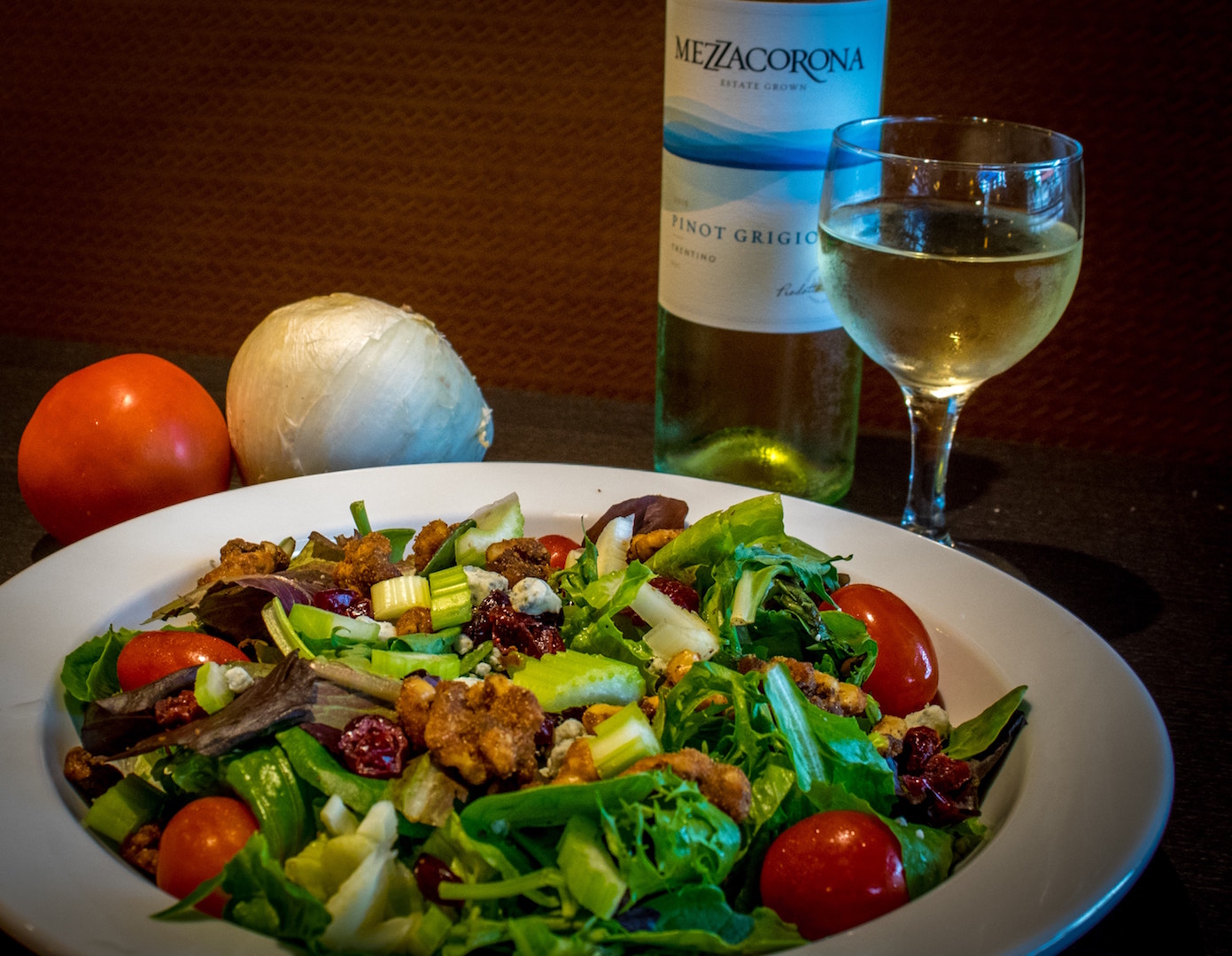 a plate of food with a glass of wine