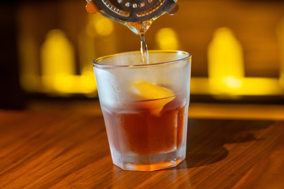 a glass of beer on a wooden table