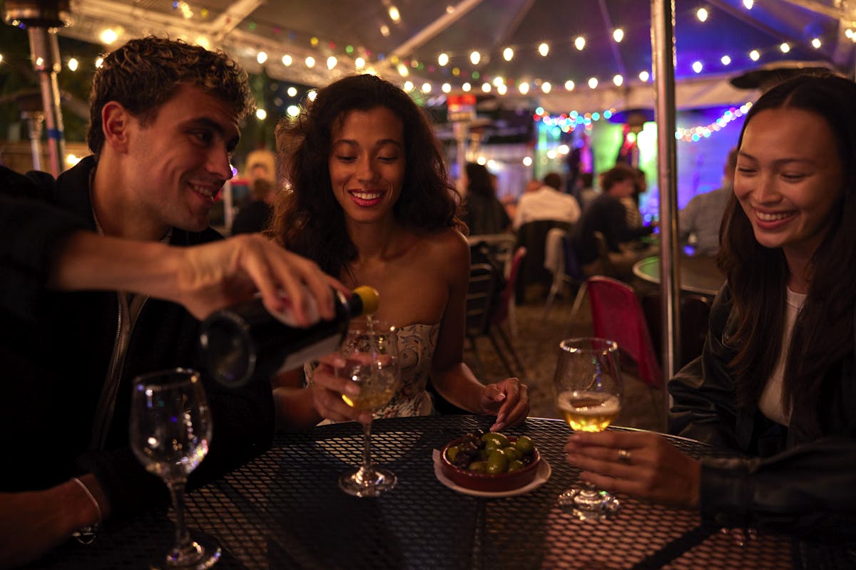 a group of people sitting at a table with wine glasses