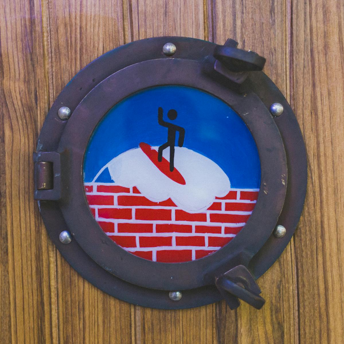 a blue clock sitting on top of a wooden table