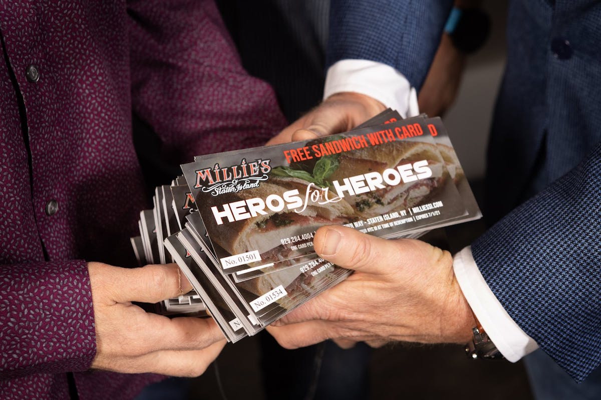 men holding heros for heros flyers