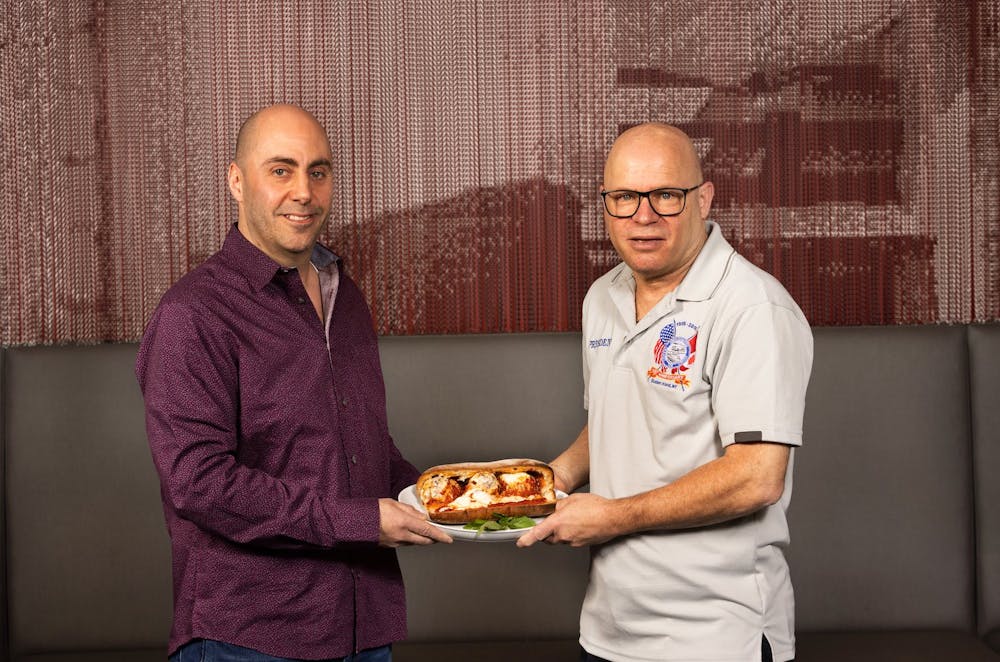 a man holding a box of food